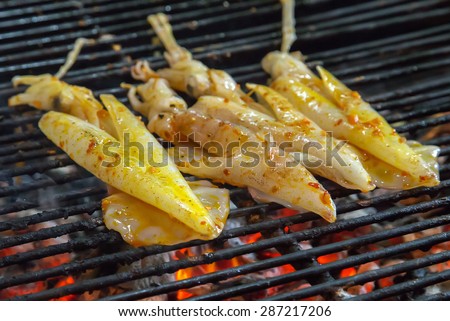 seafood Fresh squid by fire and BBQ Flames. Restaurant Barbecue at the night market