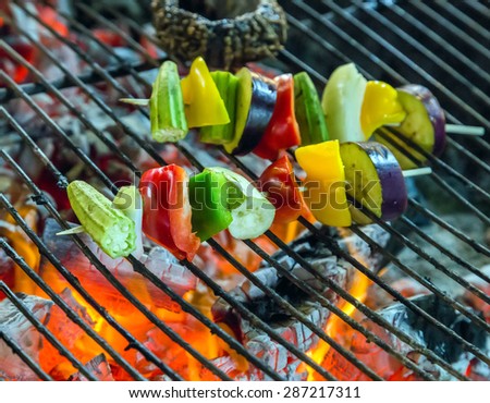 Grilled food vegetables by fire and BBQ Flames. Restaurant Barbecue at the night market