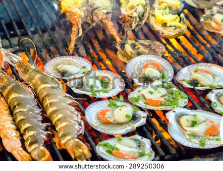 Grilling sea food on the flaming grill. Summer barbecue concept seafood.