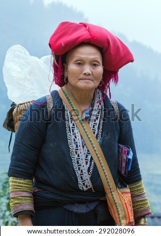 TA PHIN, LAO CAI, VIETNAM - NOV 21, 2014: Woman from Red Dao minority group wearing traditional headdress near Ban Ho village, Sapa District, Lao Cai, Vietnam.