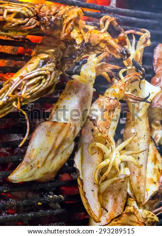 Barbecue Grill cooking grilled squids.