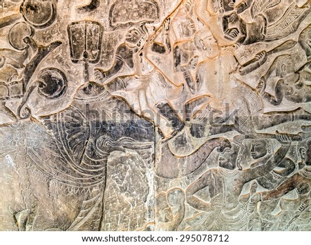 Khmer relief carving of gods fighting demons. Inner wall of the temple of Angkor Wat, Siem Reap, Cambodia.
