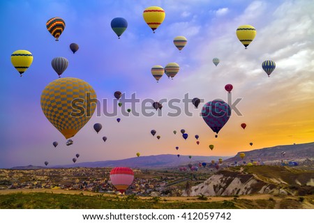 Hot Air balloons flying over Mountains landscape sunset Cappadocia, Turkey