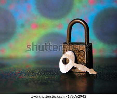 vintage lock and key on a background of Indian pattern