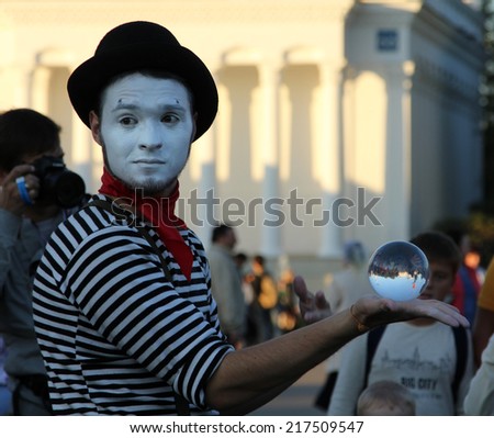 MOSCOW, RUSSIA - SEP 7, 2014: Clown with a magic crystal ball on a holiday devoted to the City Day of Moscow at All Russian Exhibition center