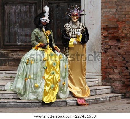 VENICE, ITALY - APR 18, 2013: Couple in carnival costumes. Carnival masks is one of the most famous symbols of Venice