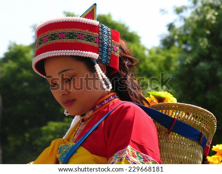SHILIN, YUNNAN, CHINA - APR 15, 2006: Beautiful woman of Sani people in colorful traditional costume. The Sani is a small ethnic group that belong to Yi minority of Southern China