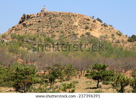 Buddhist stupa with prayers flags on top of hill, Daqing mountains near Hohhot, Inner Mongolia