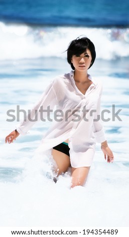 portrait of a girl of Asian appearance in a white chiffon shirt standing on a sea background, bokeh