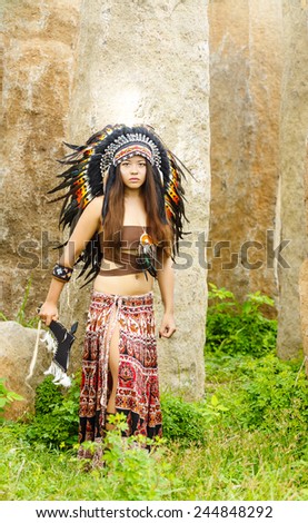 Native american, Indians in traditional dress, standing  to the stone slabs.