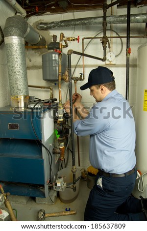 Plumber repairs furnace