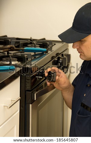 Service technician repairs stove