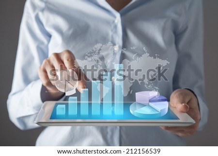 Businesswoman in front of visual touch screen.