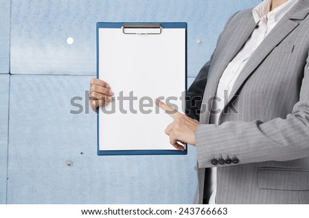 Businesswoman holding blank clipboard