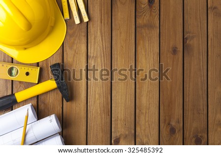 Construction tools on a wooden background
