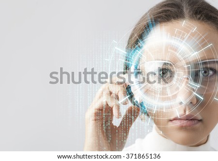 Young woman looking at virtual graphics in futuristic background