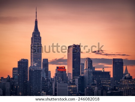 NEW YORK - NOVEMBER 29, 2014 : Sunrise over Manhattan skylyne with New Yorker sign lit up.