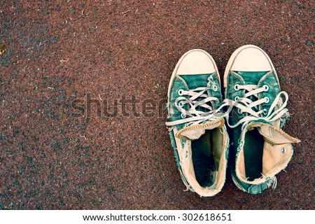 Old & Torn sneakers on Rubber flooring  ,Background layout with free text space.