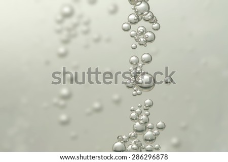 Many small fizz bubbles floating in champagne
