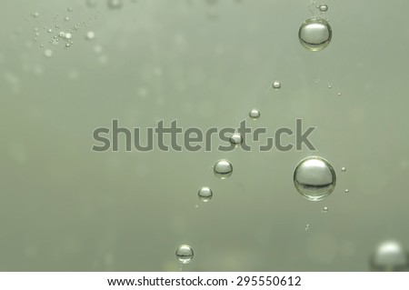 Many golden champagne bubbles over a blurred background