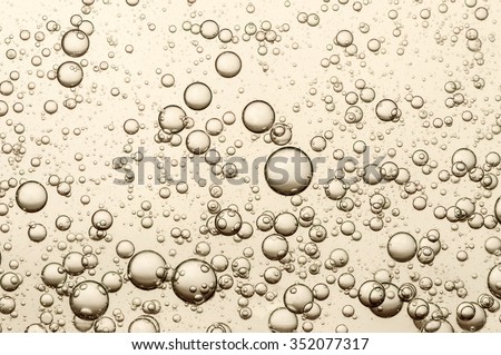 Many small champagne bubbles in a glass of champagne