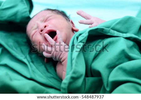 Baby crying after birth in labor room