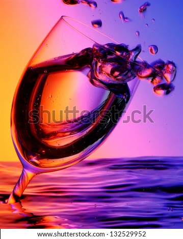Cup of water with bubbles in a colorful background