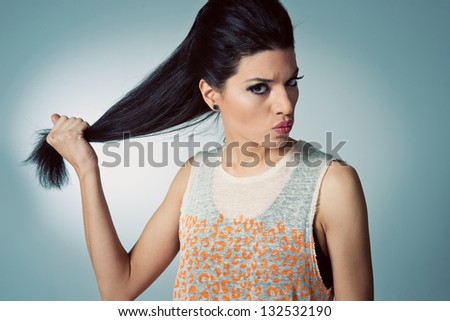 Pretty Girl with Hair Problems in a Grey Background