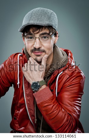 Young Cute Young Man with a Beret over a Grey Background