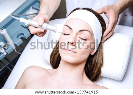 woman in a beauty clinic by becoming a facial