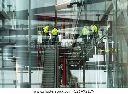Multiple layers and reflection of a modern airport building with airport workers
