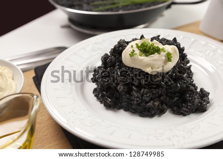 Traditional valencian dish made with rice, onion, garlic, squid and squid ink, accompanied by garlic mayonnaise sauce