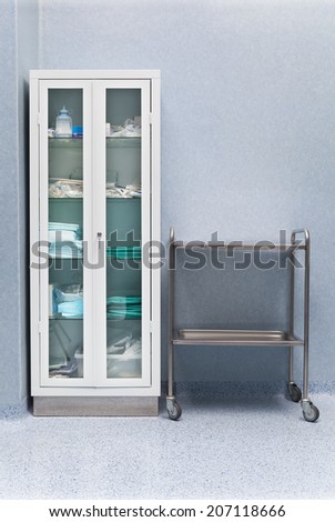 Metal cabinet with medical stuff in an operating room. Vertical composition