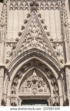 Tympanum in the Door of Saint Michael or Door of the Nativity in the Seville Cathedral, in Andalusia, Spain. It is the largest Gothic cathedral and the third-largest church in the world.