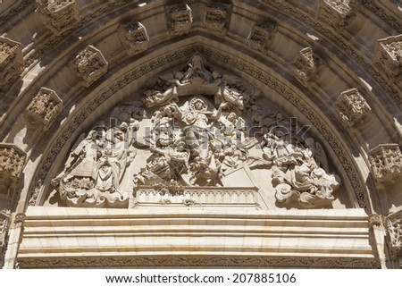 Tympanum in the Main Door or Door of Assumption in the Seville Cathedral, in Andalusia, Spain. It is the largest Gothic cathedral in the world. It\'s carved here the relief of the Assumption.