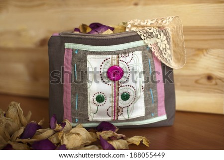 Cosmetics bag handmade in ethno style. Cosmetics bag decorated with buttons,ribbons, cords. Dried rose petals and lace inside.