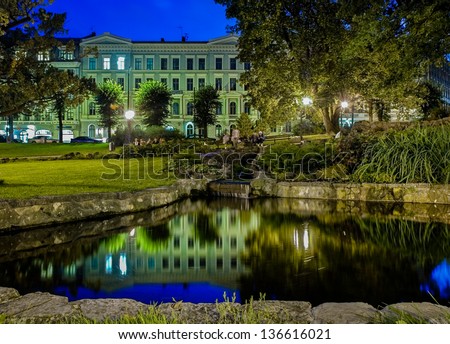 RIGA SEPTEMBER 09: a night view of a pond in the Bastejkalns Park in Riga on 09 September 2012.  The park Divides the Old Town from the Central District with the Freedom Monument in the middle