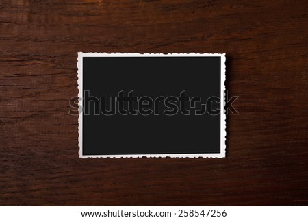 Old photograph on wooden background