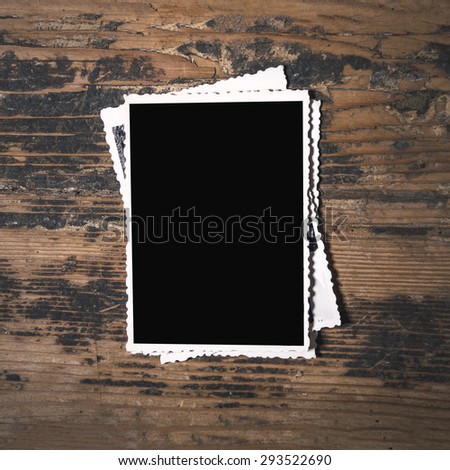 Stack of old photographs on wooden background