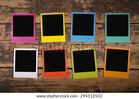 Color frames similar to polaroid on wooden background