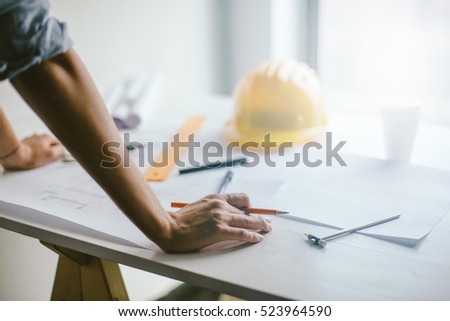 Construction engineering. Close up of engineers hands working on table
