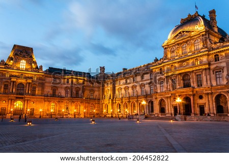 PARIS - MAY 10 : Louvre museum at twilight in summer on May 10,2014. Louvre museum is one of the world\'s largest museums