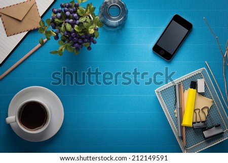 Office workplace,office Equipment and coffee break on blue crepe paper desk