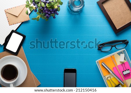Office workplace,office Equipment and coffee break on blue crepe paper desk