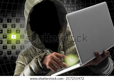 Hacker stealing data from a laptop , identity theft and computer crime