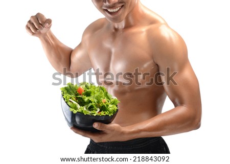 A muscular guy and fresh Salad bowl,shaped abdominal, isolated on white background