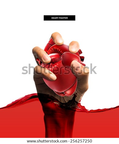 Heart protection medical concept,Heart shape made from boxing glove in hand and blood,isolated on white