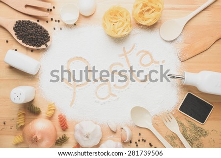 Rural kitchen utensils on wooden table and flour with text from above - rustic background with free text space,vintage style
