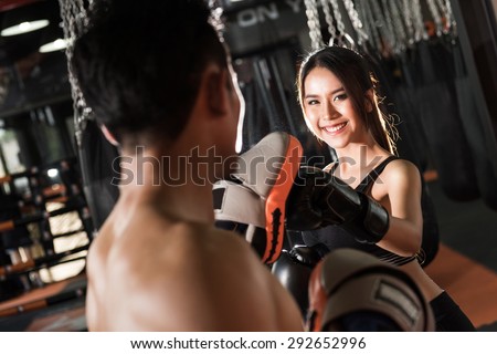 woman training with boxing gloves at the gym,Couple exercising punching
