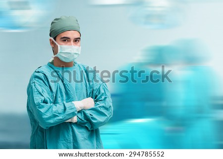 Surgeon at operating room in the hospital,looking at camera,motion blur background , Surgeon at operating room in the hospital,looking at camera,motion blur background. blue filler
